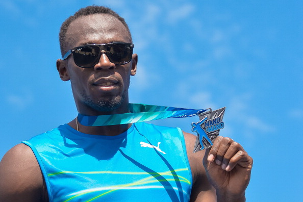 Usain Bolt shows off his medal for winning the Mano a Mano 100m challenge on Copacabana Beach last weekend. He has now ended his season early ©Getty Images