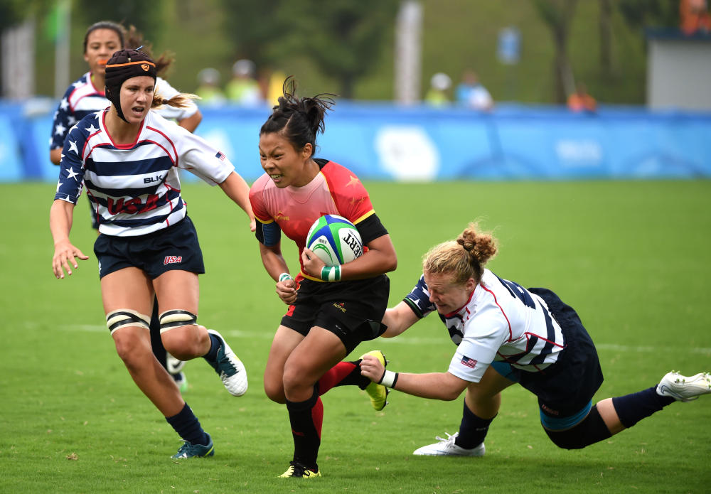 Liu Xiaoqian of China with the ball in a women's rugby sevens pool match against the United States, which the hosts won 29-7 ©Nanjing 2014