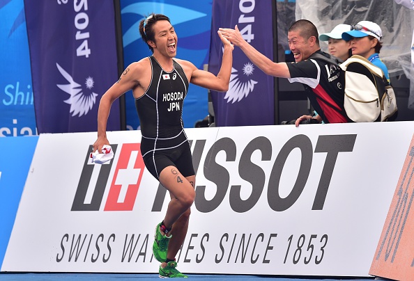 A high-five for Japan's Yuichi Hosoda as he helped his team to gold in the mixed team relay triathlon ©AFP/Getty Images