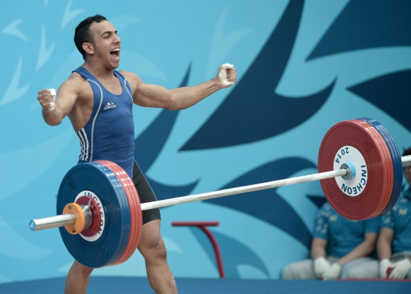 Al Saleem Mansour Abdulrahim of Saudi Arabia was happy with his successful attempt in the men's 56kg weightlifting ©AFP/Getty Images
