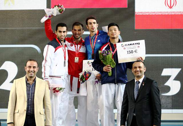 Ali Sofuoğlu raises his arm in triumph after delighting the home fans with victory in the men's kata category ©WKF