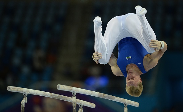 Eduard Shaulov of Uzbekistan in individual qualification and team final action on the parallel bars ©AFP/Getty Images