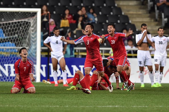 North Korea's players celebrate their win against Iraq during their men's semi-final football match ©Getty Images
