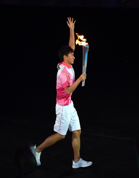 Zhang Jike carrying the Olympic Torch at the Opening Ceremony of Nanjing 2014 last month ©Getty Images