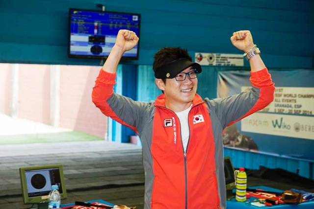 South Korea's Jin Jongoh celebrates after claiming gold in the men's 50 metre pistol final and breaking a 34-year-old world record set before he was even born ©ISSF