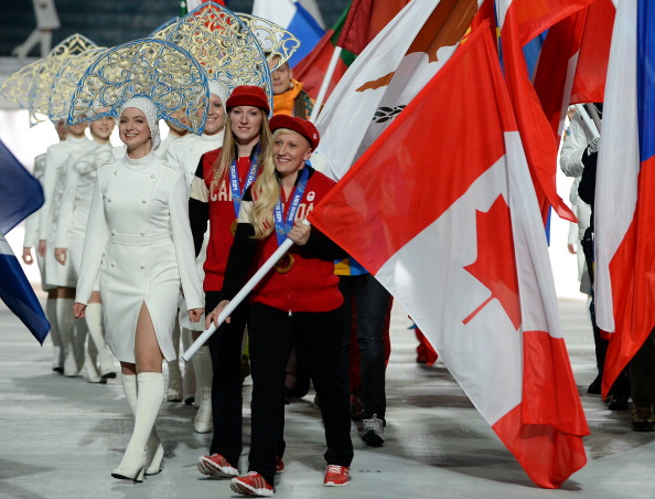 Kaillie Humphries (pictured carrying the flag) is keen to pilot a four-man bobsleigh pushed by three male team mates in the upcoming season ©Getty Images