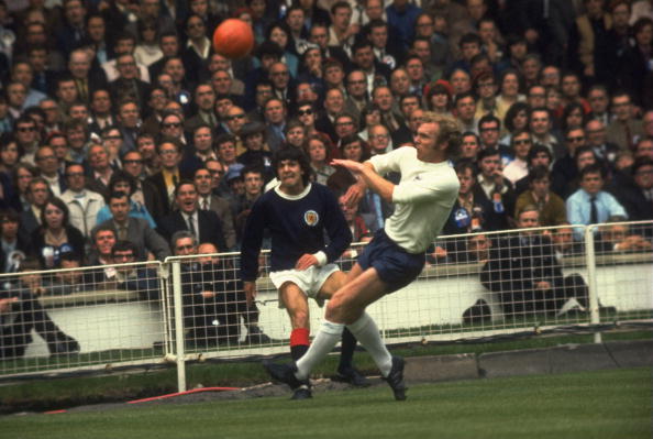 Scotland's Peter Cormack gets a cross in despite the attentions of Bobby Moore during England's 3-1 win at Wembley in 1971. The Scots sang "All we are say-ing is give us a goal", to the tune of John Lennon's Give Peace A Chance. But Scotland only managed one of those in five successive games against the Auld Enemy in the early 1970s ©Allsport/Getty Images