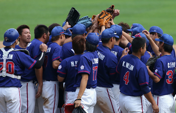 A team hug of sorts for players from Chinese Taipei, who beat Japan 10-4 in their baseball semi-final ©Getty Images
