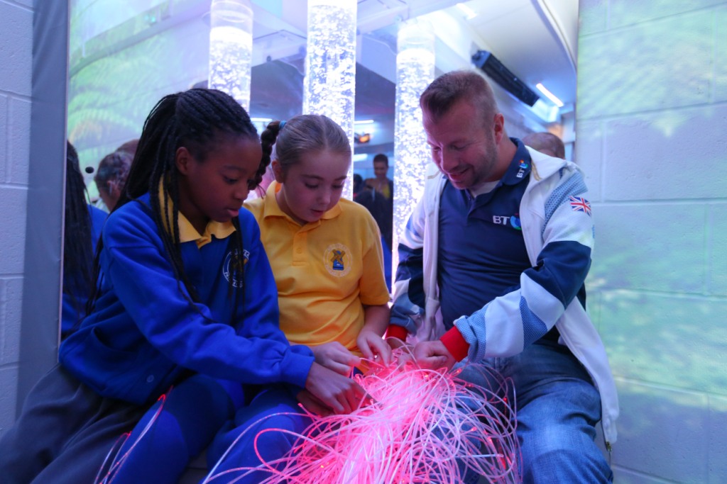 Lee Pearson interacts with children from Millstead School in the new BT Multi-Sensory Room ©Dave Thompson