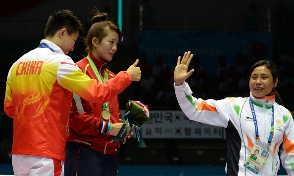 Indian boxer Sarita Devi has apologised for her behaviour during the medal ceremony, when she refused to accept her bronze medal in protest at the judging ©AFP/Getty Images