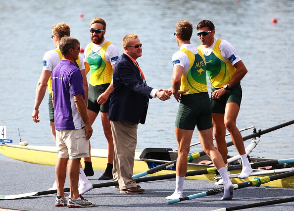 John Coates shakes hands with the victorious Australian men's four crew during the Rowing World Cup at the Sydney International Rowing Centre in March ©Getty Images
