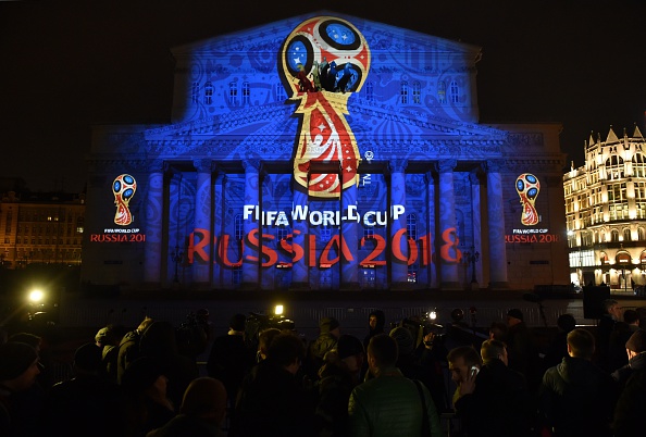 The Bolshoi Theatre is illuminated with the official emblem of the 2018 FIFA World Cup as people watch ©Getty Images