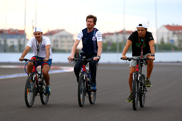 Williams driver Felipe Massa (right) rides his bike on the track as he gets early knowledge of the Sochi Autodrom ©Getty Images