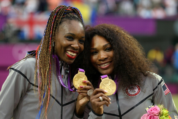 Serena and Venus Williams celebrate winning the women's doubles at London 2012, the fourth Olympic gold medal for each player ©Getty Images