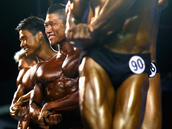 Bodybuilders pose on the opening day of action in the sport ©Getty Images