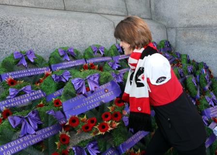 Caroline Bisson, Sochi 2014 Paralympian in Para-Nordic skiing, lays a wreath on behalf of Canadian Paralympic athletes at the Remembrance Day ceremony ©Greg Kolz