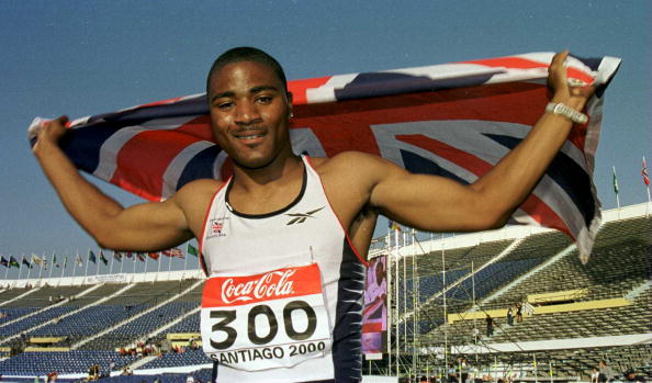 Mark Lewis-Francis celebrates a 100m gold at the 2000 IAAF World Junior Championships - Olympic gold would follow, but in the relay, not the individual event ©Getty Images
