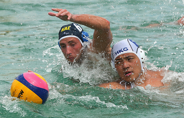 Players from Hong Kong and Kazakhstan battle for the ball in a men's water polo clash ©Phuket 2014