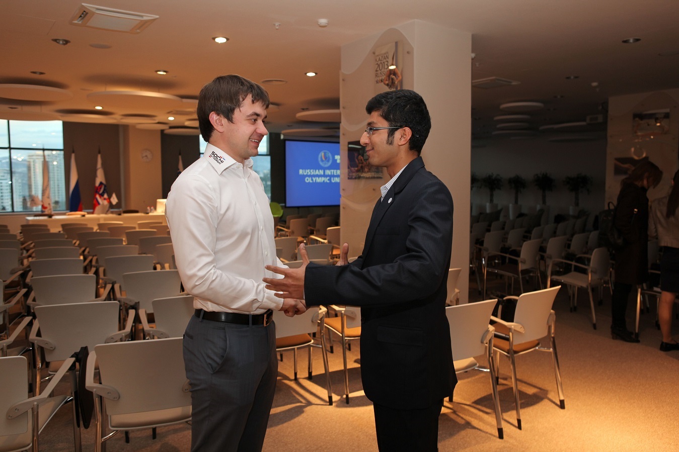 Sergei Vorobyev (left), deputy general director of Russian Grand Prix promoters Omega Centre, speaks with Parth Kalke (right), a RIOU MSA student ©RIOU