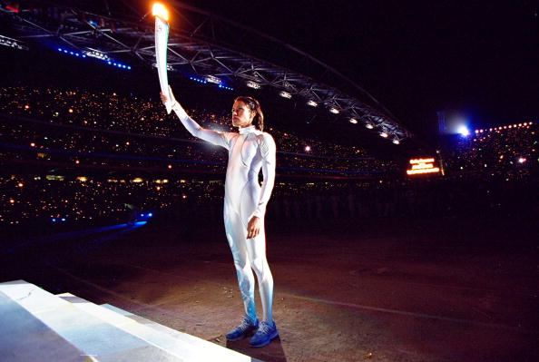 Cathy Freeman holds aloft the Olympic Flame during the Sydney 2000 Opening Ceremony ©Getty Images