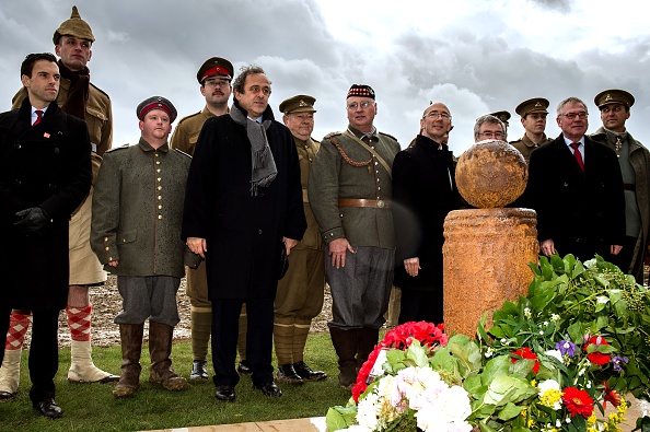 UEFA President Michel Platini (pictured fifth from left) during the inauguration of a monument to commemorate the World War One soldiers of opposite camps who played a game of football together during a Christmas ceasefire ©Getty Images
