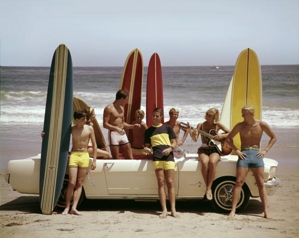'When you think of California...you think of surfing"  - guys, gals, guitar - and a Ford Mustang - on the beach in 1964 ©Getty Images