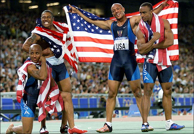 Jon Drummond (right) celebrates the US winning the Olympic 4x100 metres gold medal at Sydney 2000 ©Getty Images