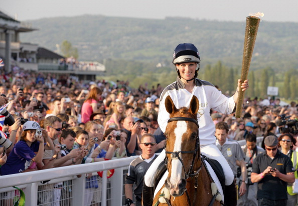 Zara Phillips, riding Toytown, carries the Olympic Torch at Cheltenham in the lead-up to London 2012 ©Getty Images