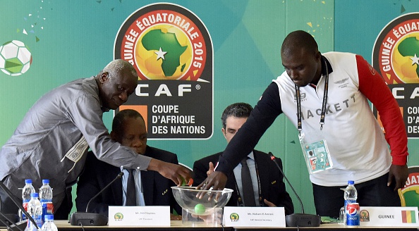 President of the Malian Football Federation Baba Diarra, CAF President Issa Hayatou, CAF secretary general Icham El Amrani and financial director of Guinea's Sports Ministry Amara Dabo take part in a draw between Mali and Guinea ©Getty Images