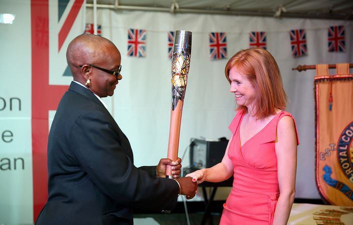 Saint Lucia Olympic Committee President Fortuna Belrose, pictured (left) during the Queen's Baton Relay ahead of the Glasgow 2014 Commonwealth Games, has revealed the funding ©Glasgow 2014