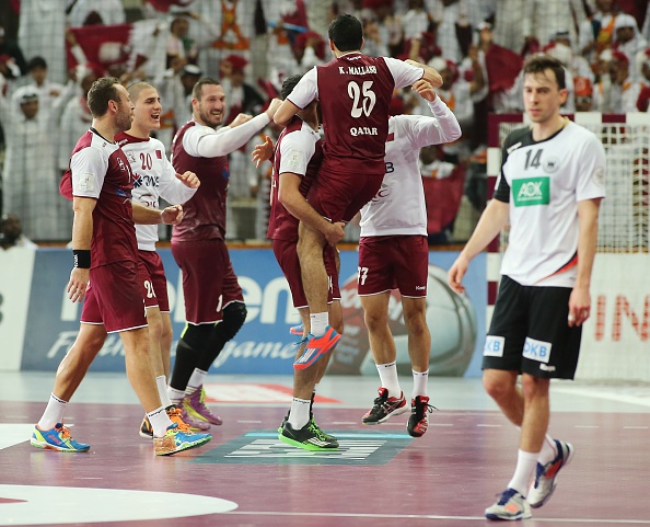 Qatar's band of mostly naturalised players celebrate their historic quarter-final win over Germany at the World Handball Championships in Lusail ©Getty Images