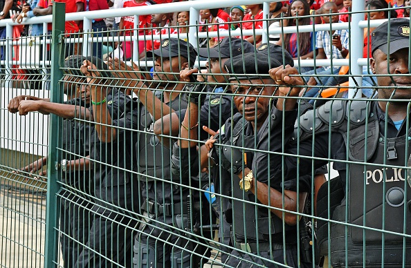 Policemen stand guard outside the Stadium to stop more fans piling inside ©AFP/Getty Images
