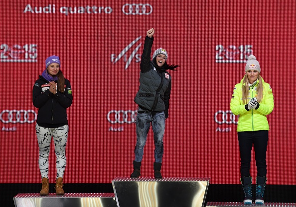 Anna Fenninger celebrates her victory in between runner-up Tina Maze (left) and third placed Lindsey Vonn (right) ©AFP/Getty Images