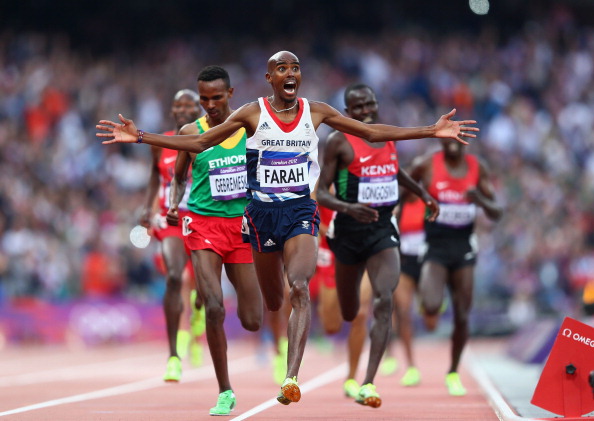 Mo Farah celebrates as he crosses the line to win the 5,000m event at London 2012 ©Getty Images
