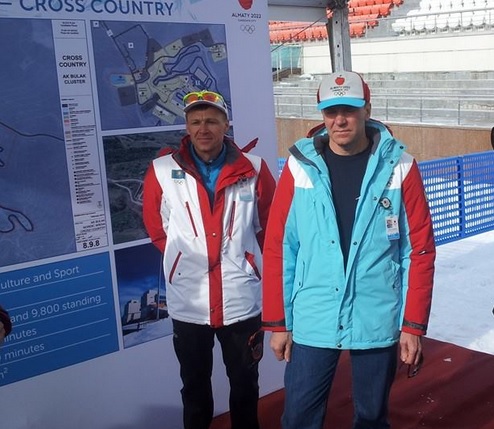 Officials, including Kazakhstan's first Olympic champion, skier Vladimir Smirnov (right), explain the concept of the Ak Bulak Nordic Centre ©ITG