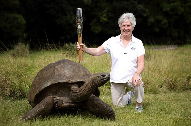 Louise Martin pictured carrying the Glasgow 2014 Queen's Baton in St Helena last February ©Glasgow 2014