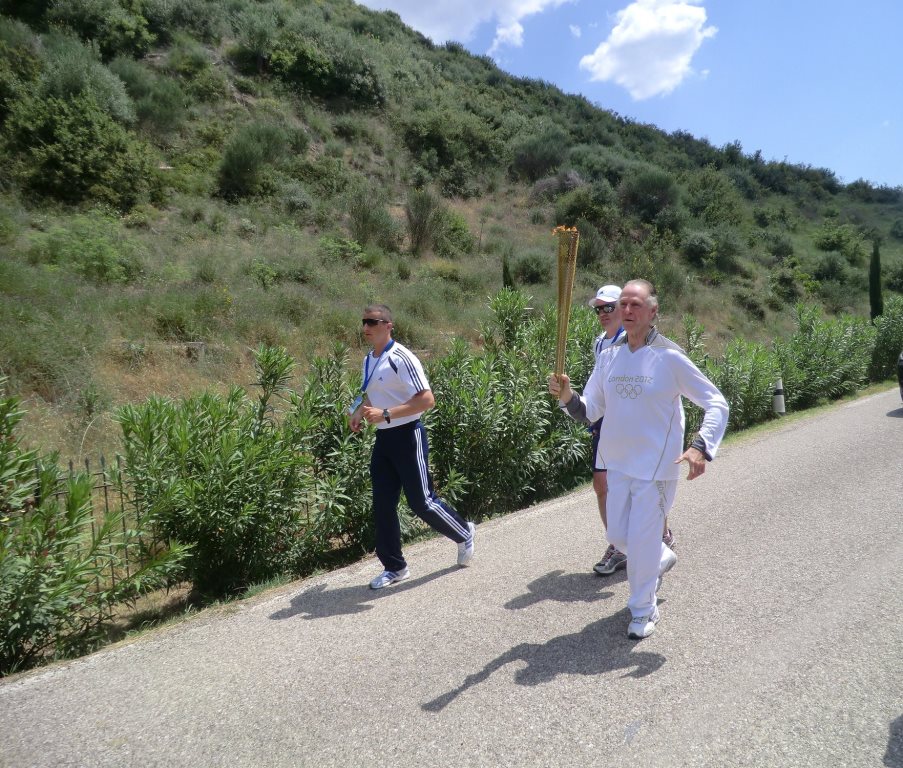 Rio 2016 President Carlos Nuzman carries the Flame along the road from Ancient Olympia in 2012 ©ITG