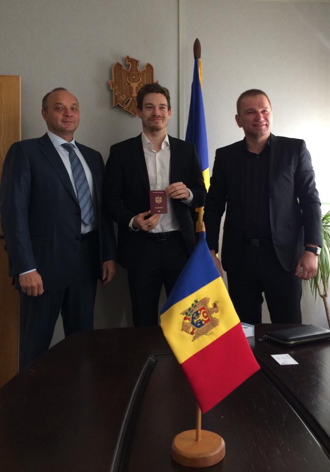 Aaron Cook shows off his Moldovan passport alongside Iulian Fruntaşu, Republic of Moldova Ambassador to the UK and Igor Yuzefovic, President Republic of Moldova Taekwondo Federation ©Facebook