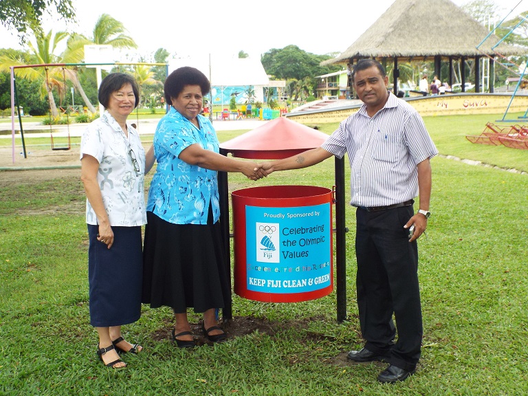 Lorraine Mar and Makarita Lenoa donate the bins to Naresh Narayan in Suva ©FASANOC