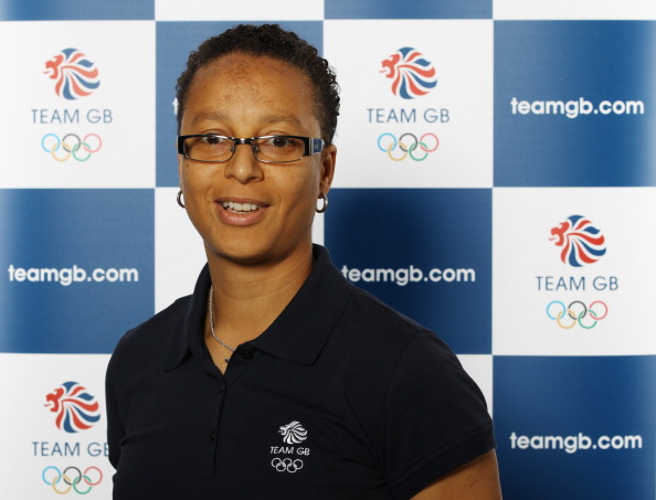 Hope_Powell_in_front_of_Team_GB_logo