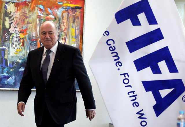 Sepp_Blatter_in_front_of_FIFA_flag