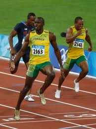 Usain_Bolt_crosses_line_in_100m_at_Beijing_2008