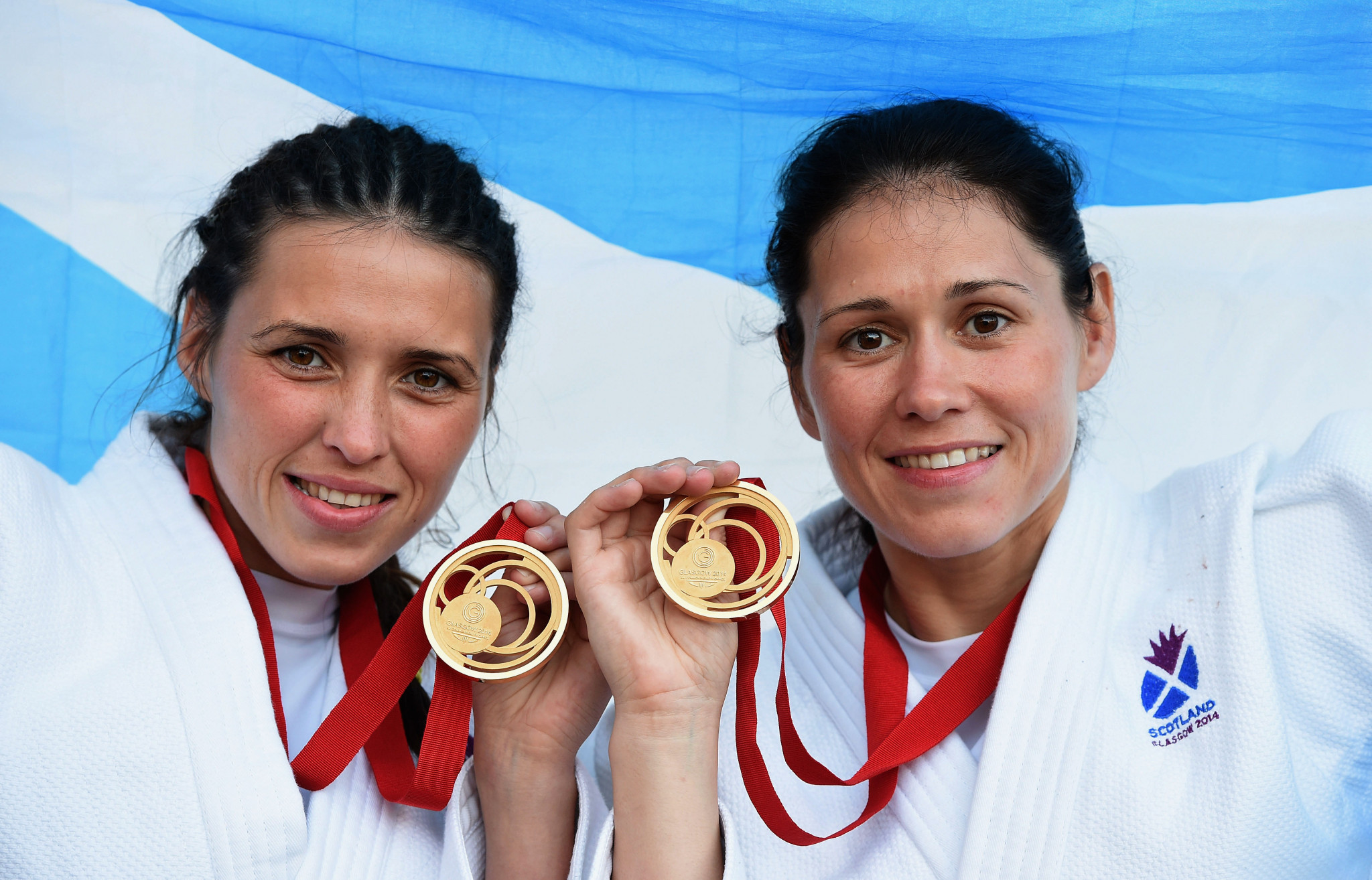 (L-R) Gold medal winning sisters Kimberley Renicks of Scotland (Women’s -48kg judo) and Louise Renicks of Scotland (Women’s -52kg judo) pose at SECC Precinct during day one of the Glasgow 2014 Commonwealth Games ©Getty Images