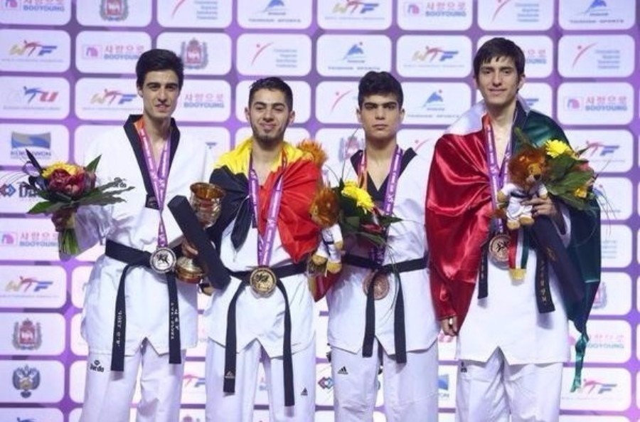 Jaouad Achab (second left) wrapped in the Belgium flag after winning World Championship gold in Chelyabinsk ©WTF